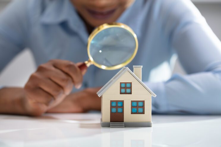magnifying glass over model house
