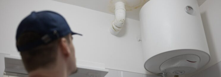 man using leak detection on ceiling