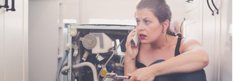 woman attempting diy leak repair