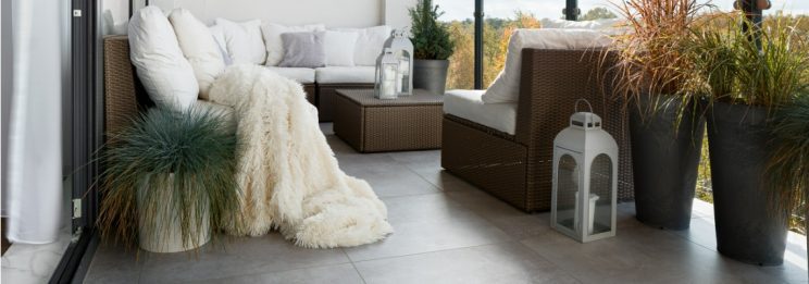 decorated tiled balcony with couches and heaters